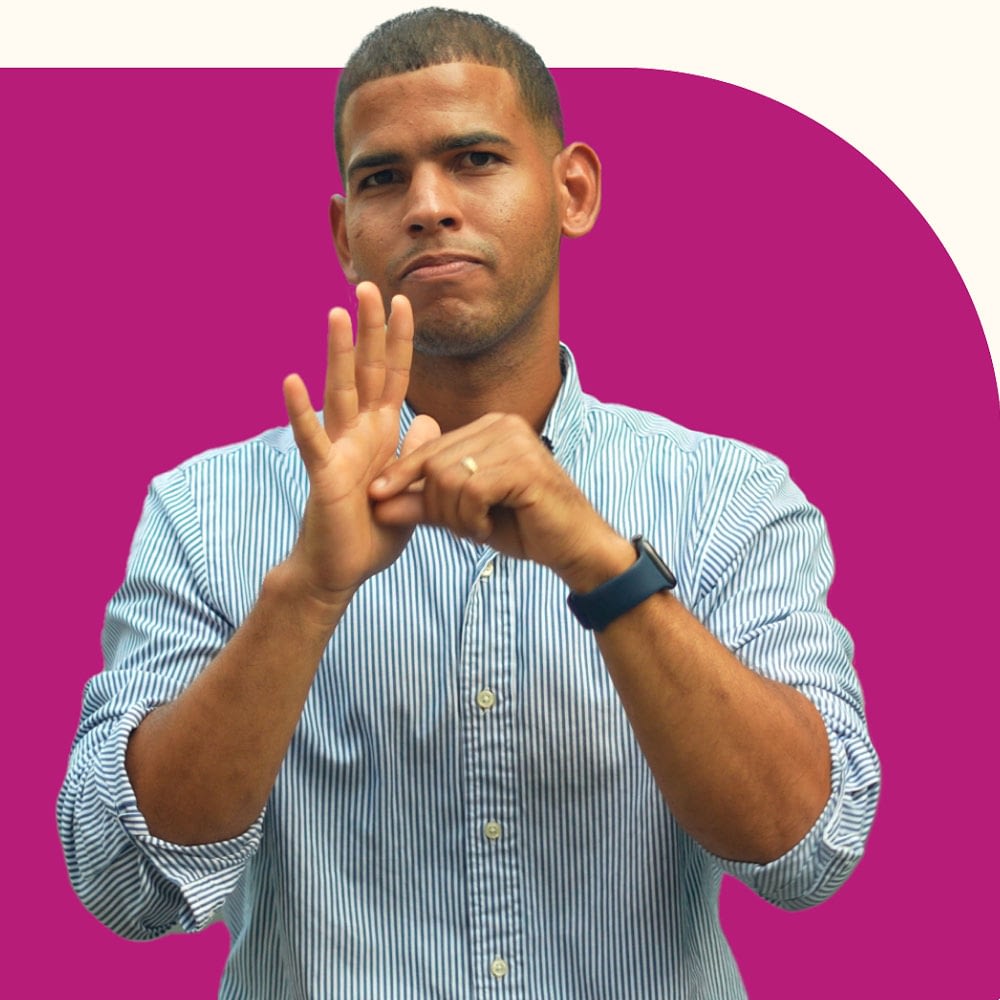 Image of a man signing in front of a shape background