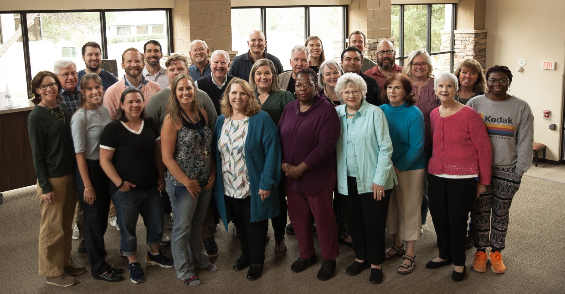 Large diverse group posing indoors for group photo