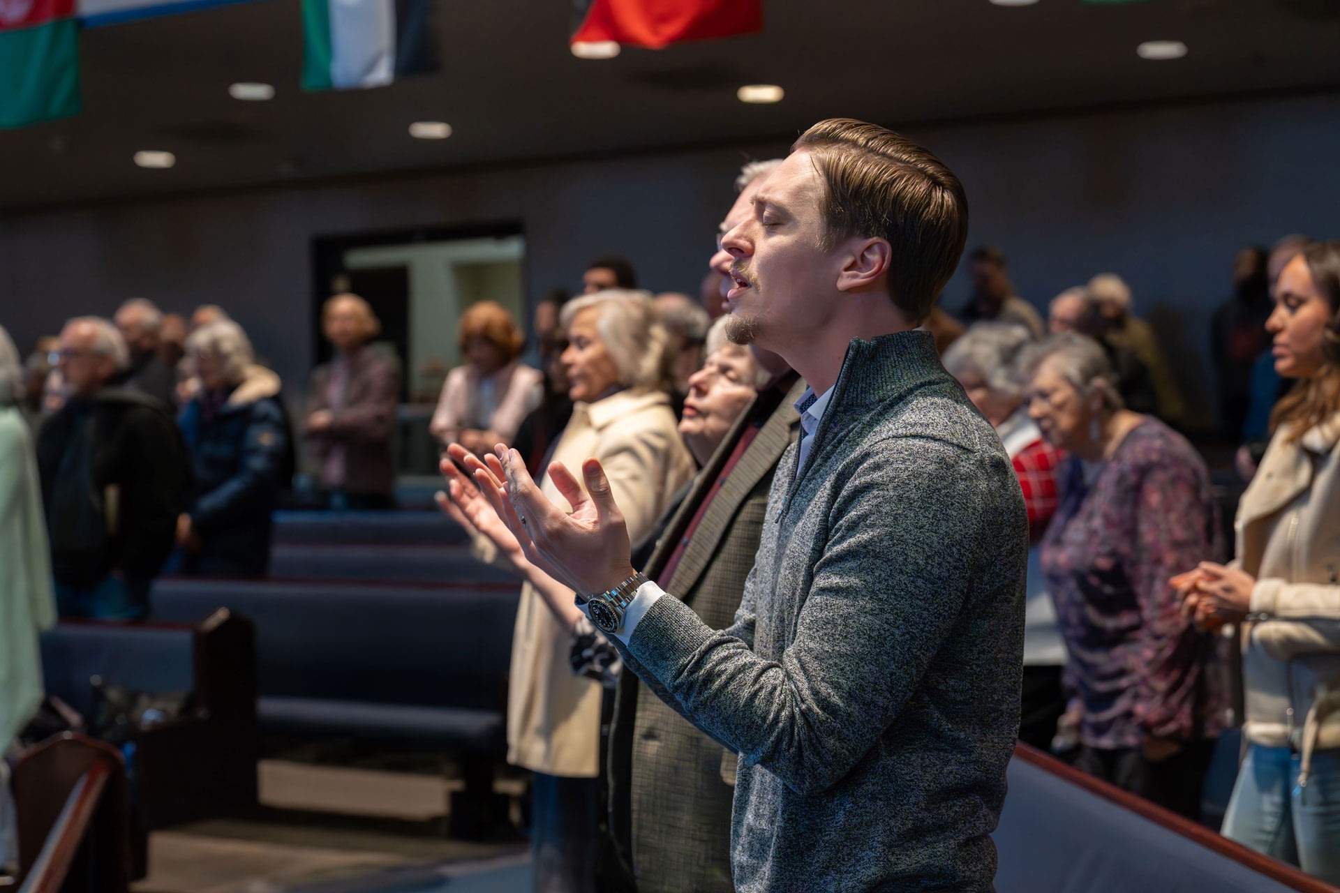 Man praying with congregation in church