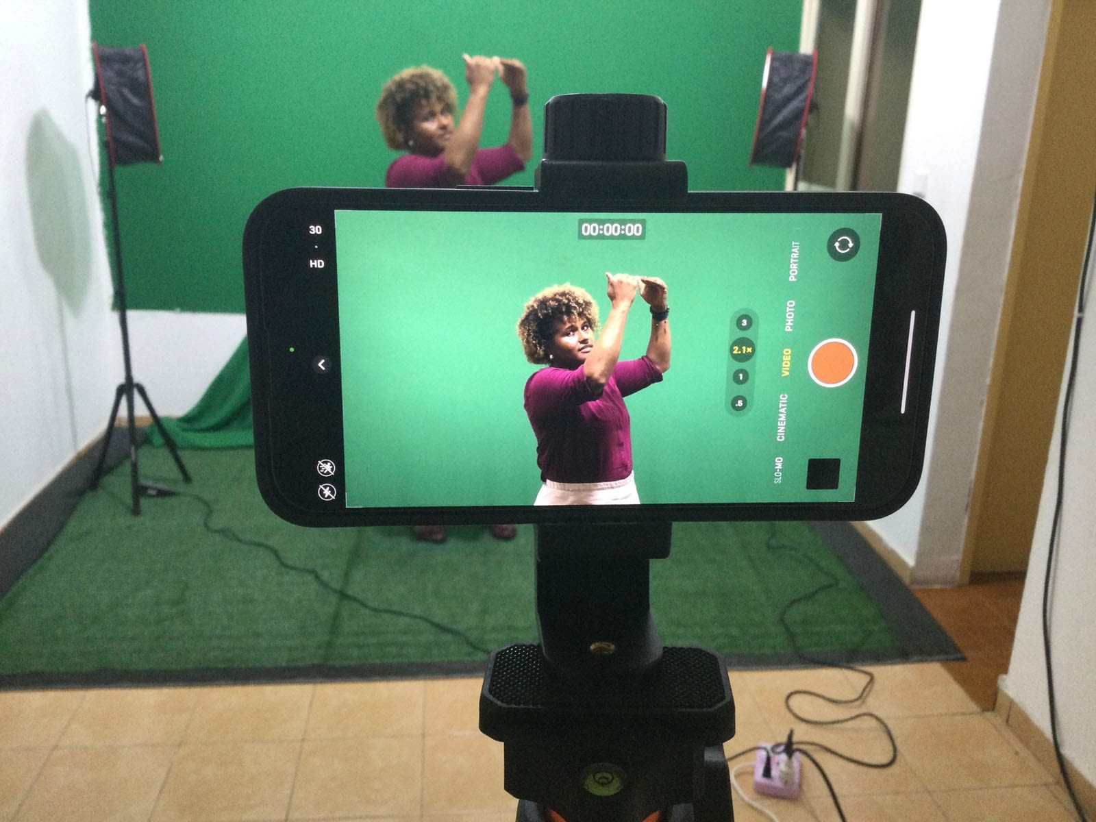 Woman recording in front of green screen