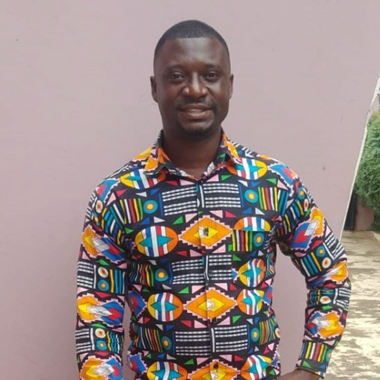 Man in colorful patterned shirt smiling