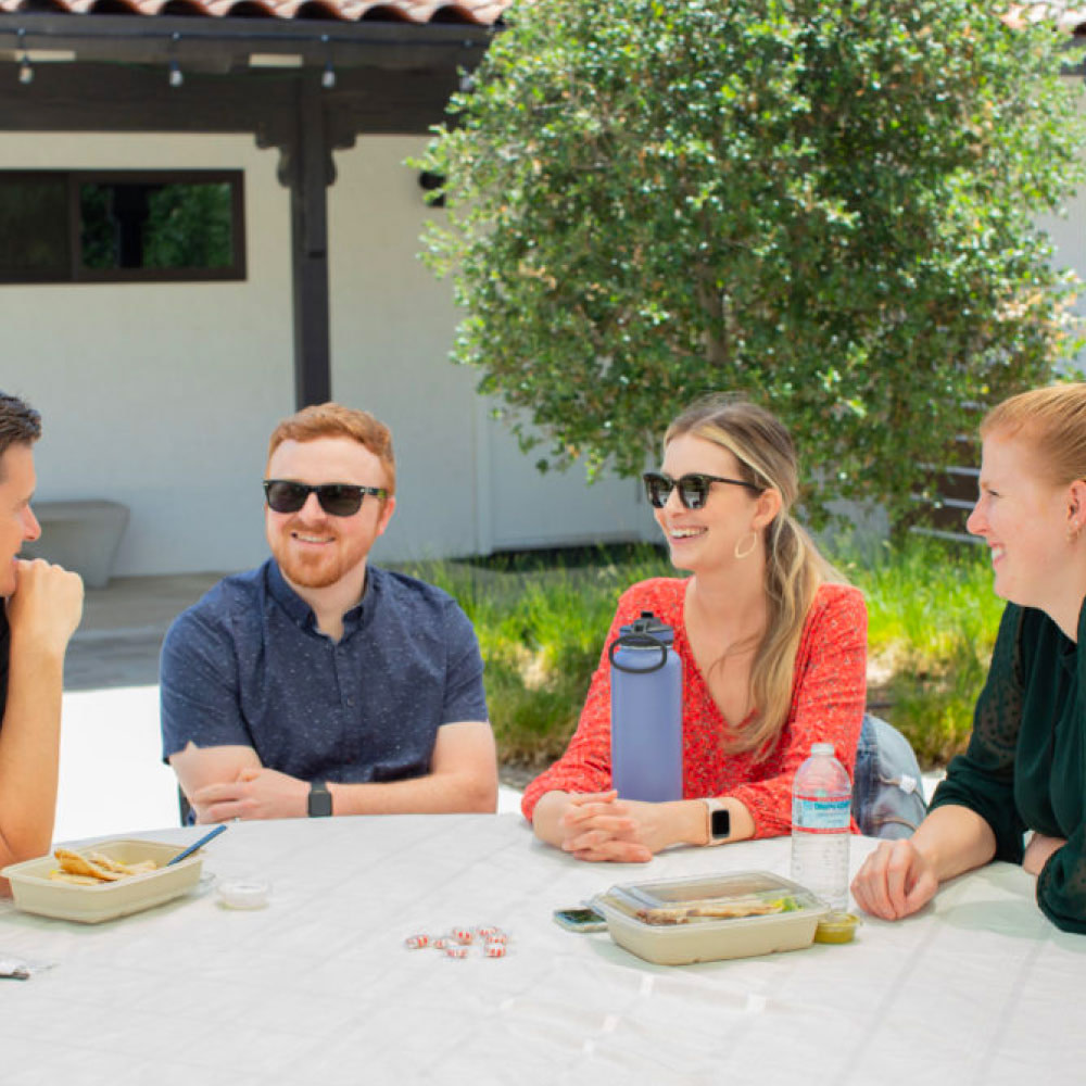 Young adults hanging out around a table