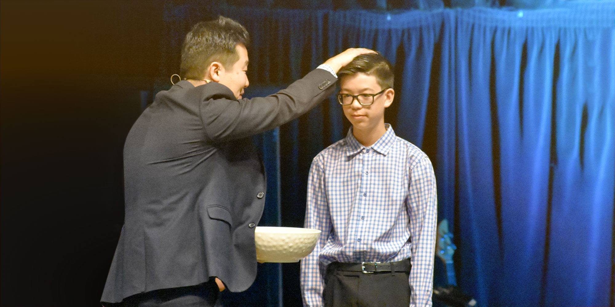 Pastor baptizing boy