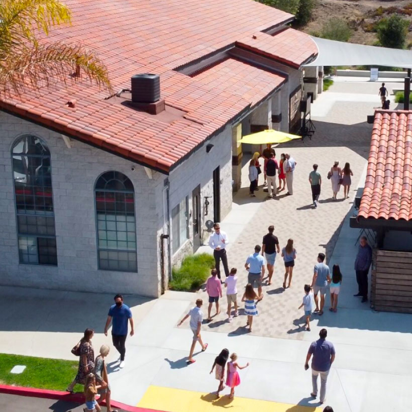 Aerial view of Redeemer Presbyterian Church in San Diego. People can be seen walking on the campus.