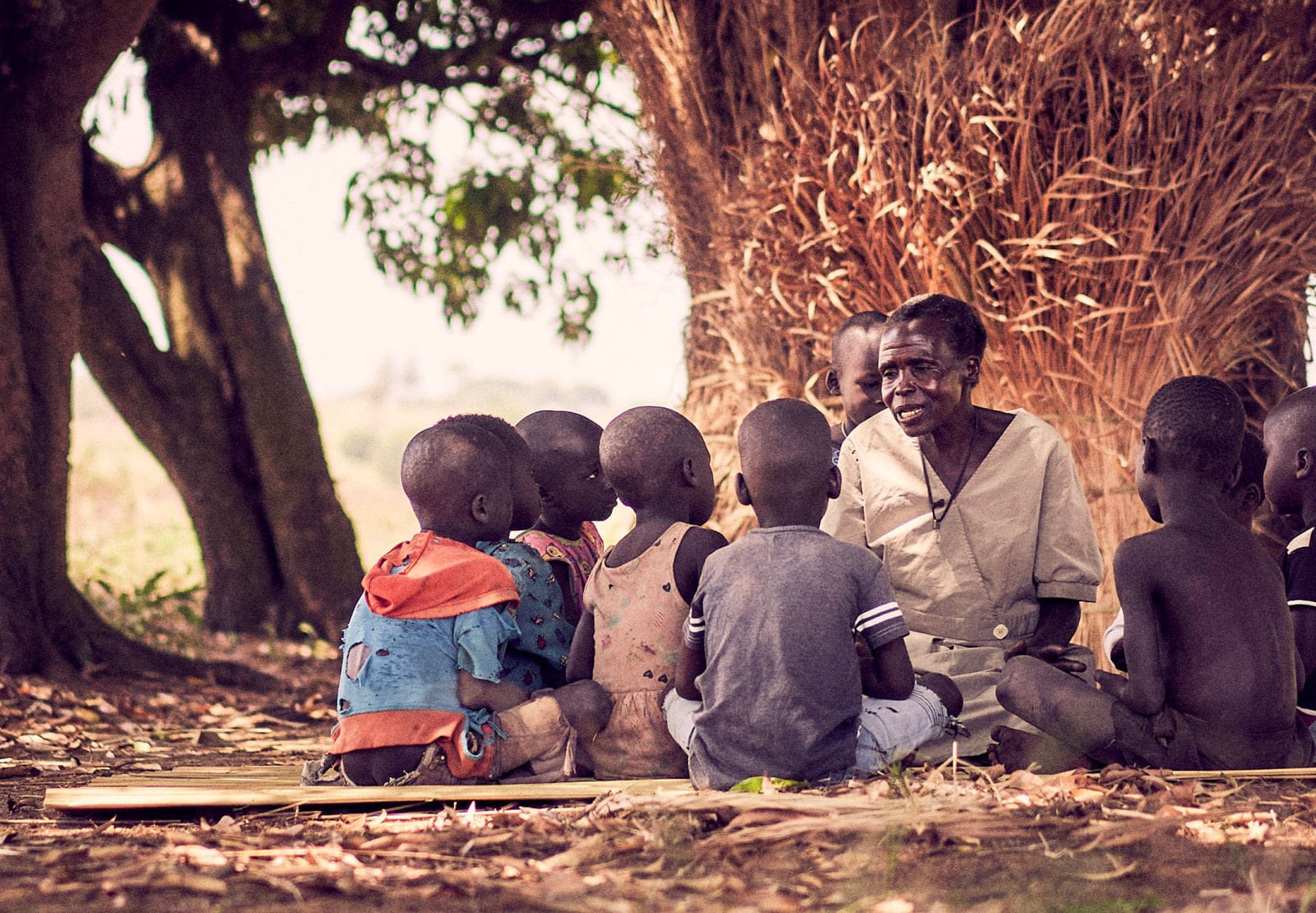 Woman speaking to a group of children