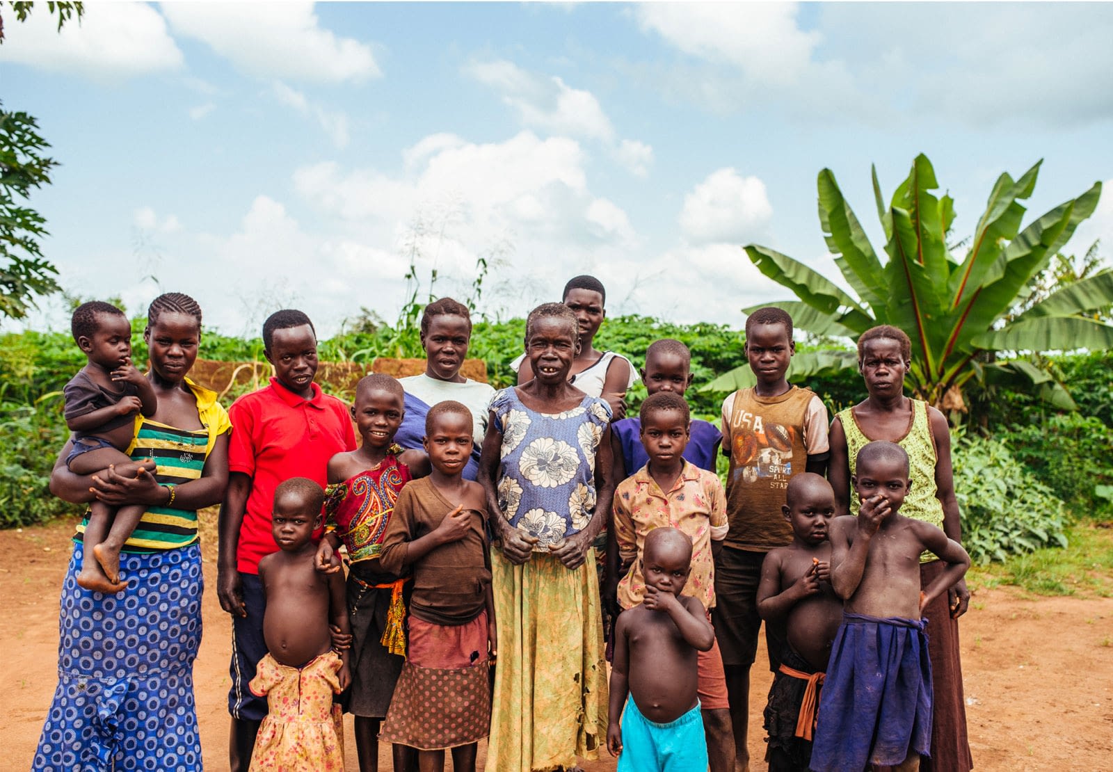 Large group of Ugandans posing for group photo outdoors