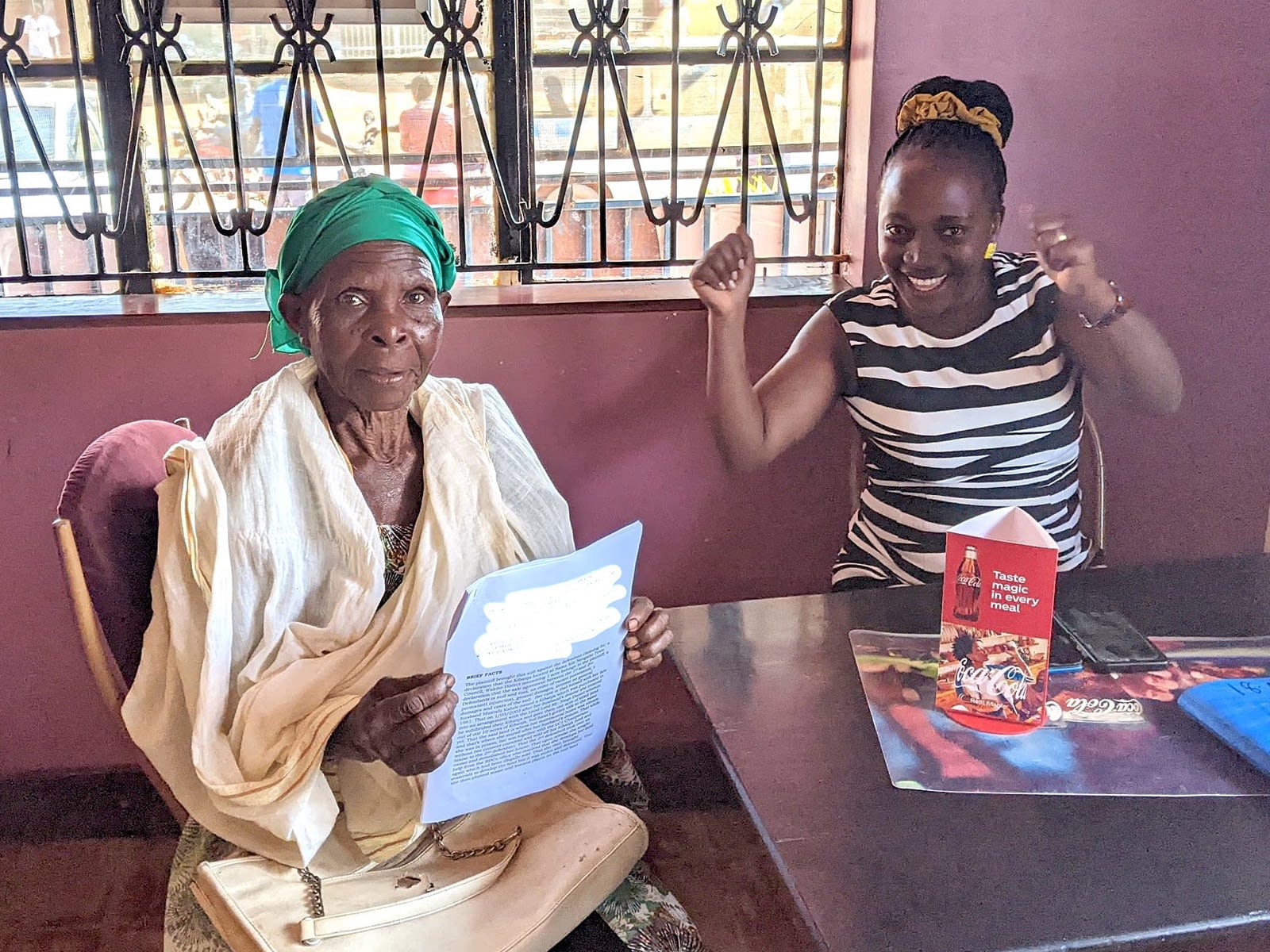 Mariam celebrates with her Redeem social worker after her legal victory.