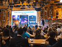 Crowded charity auction featuring Ford Amphitheater firepit tickets