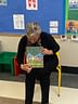 Teacher displays We Are Together book in classroom
