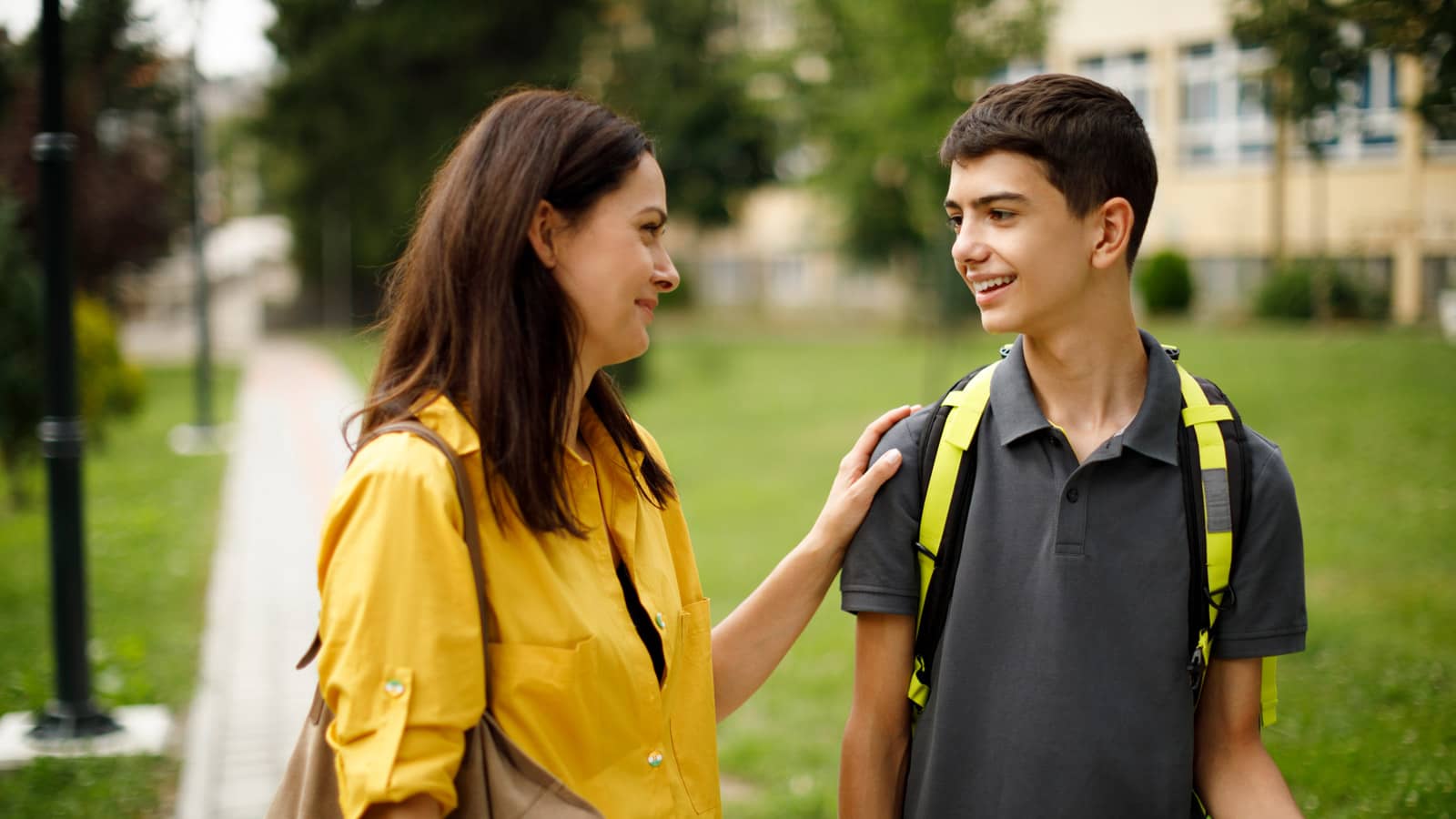 Mom talks with her son at school.