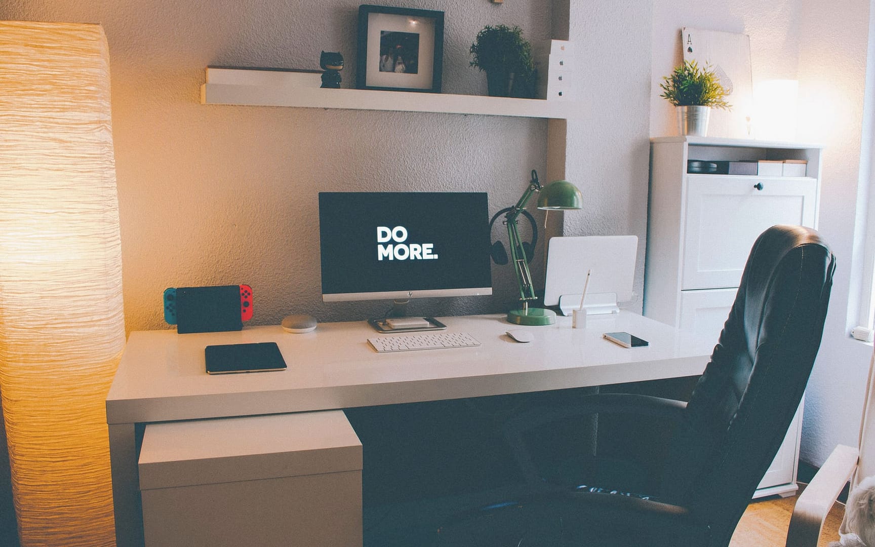 Computer on a desk with the words "Do more" on the screen
