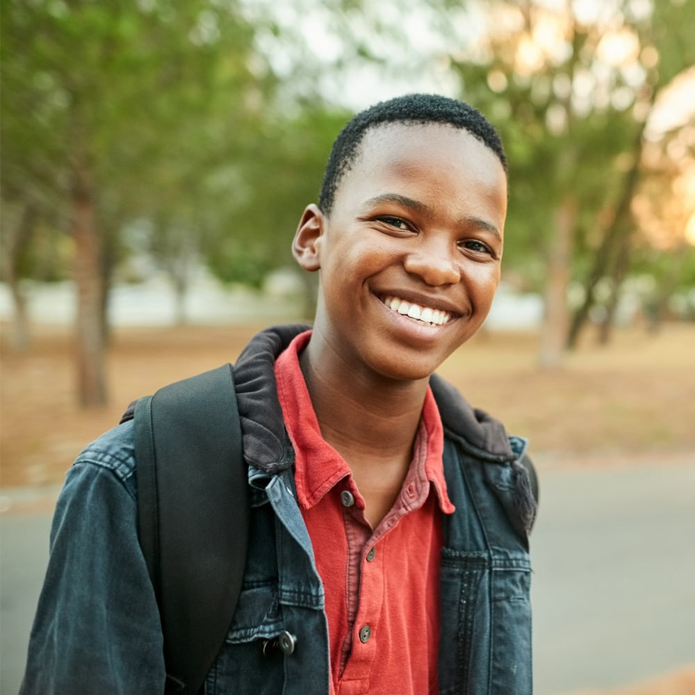 Smiling student outdoors with backpack