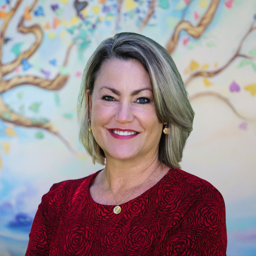 Smiling woman in red floral-patterned dress