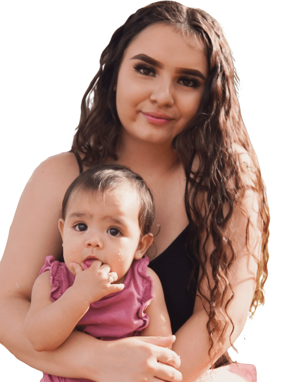 Woman holding baby and smiling.