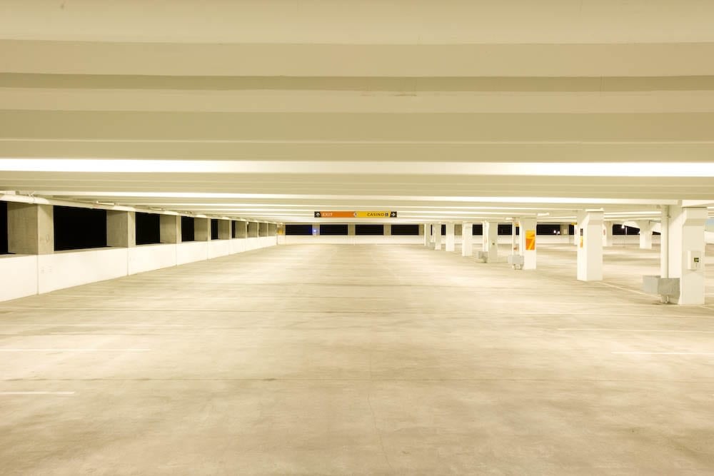 Empty indoor parking garage with bright lighting.