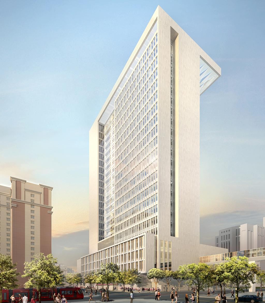 Modern tall building with glass facade and trees.