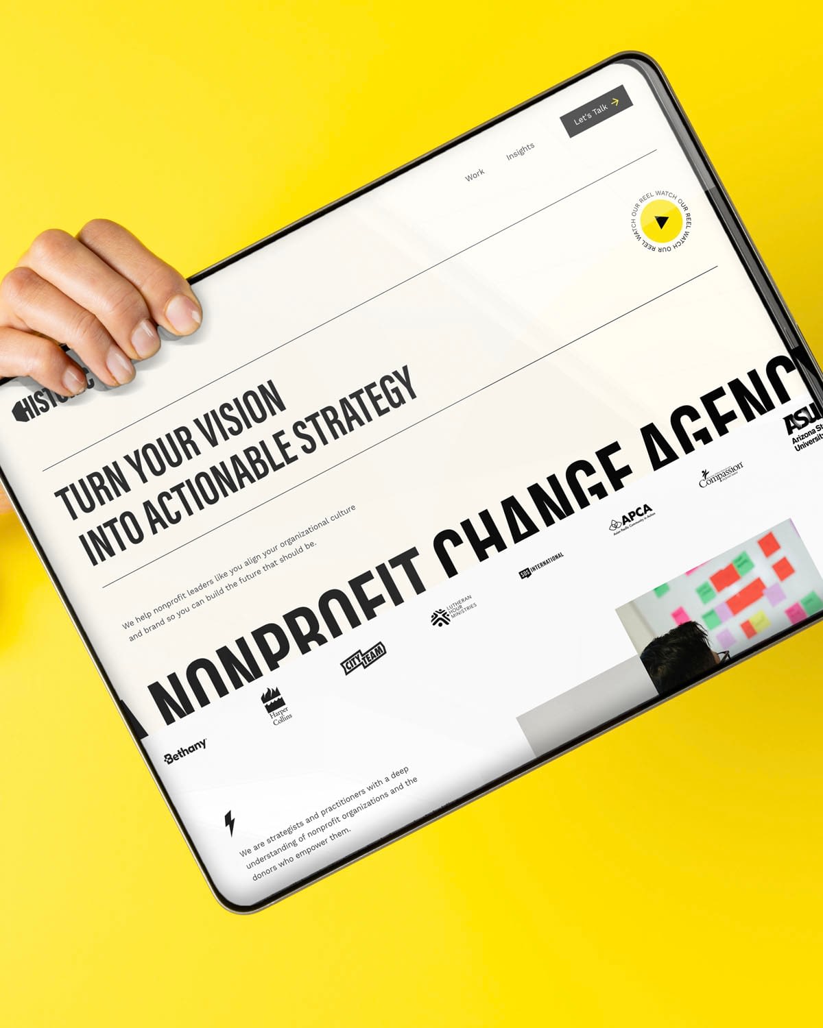 Tablet displaying nonprofit strategy website on yellow background.