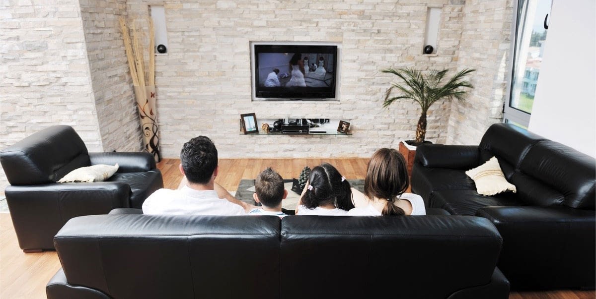 Family on couch watching TV