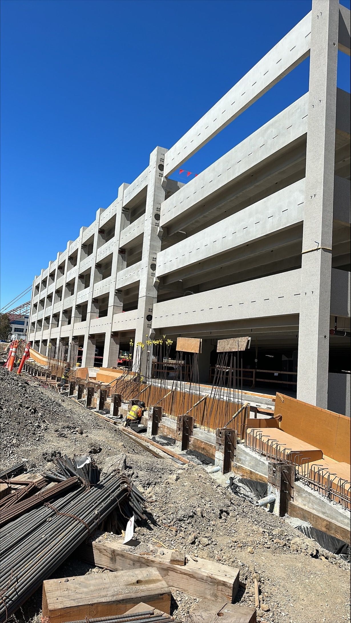 Construction worker at large parking garage site.