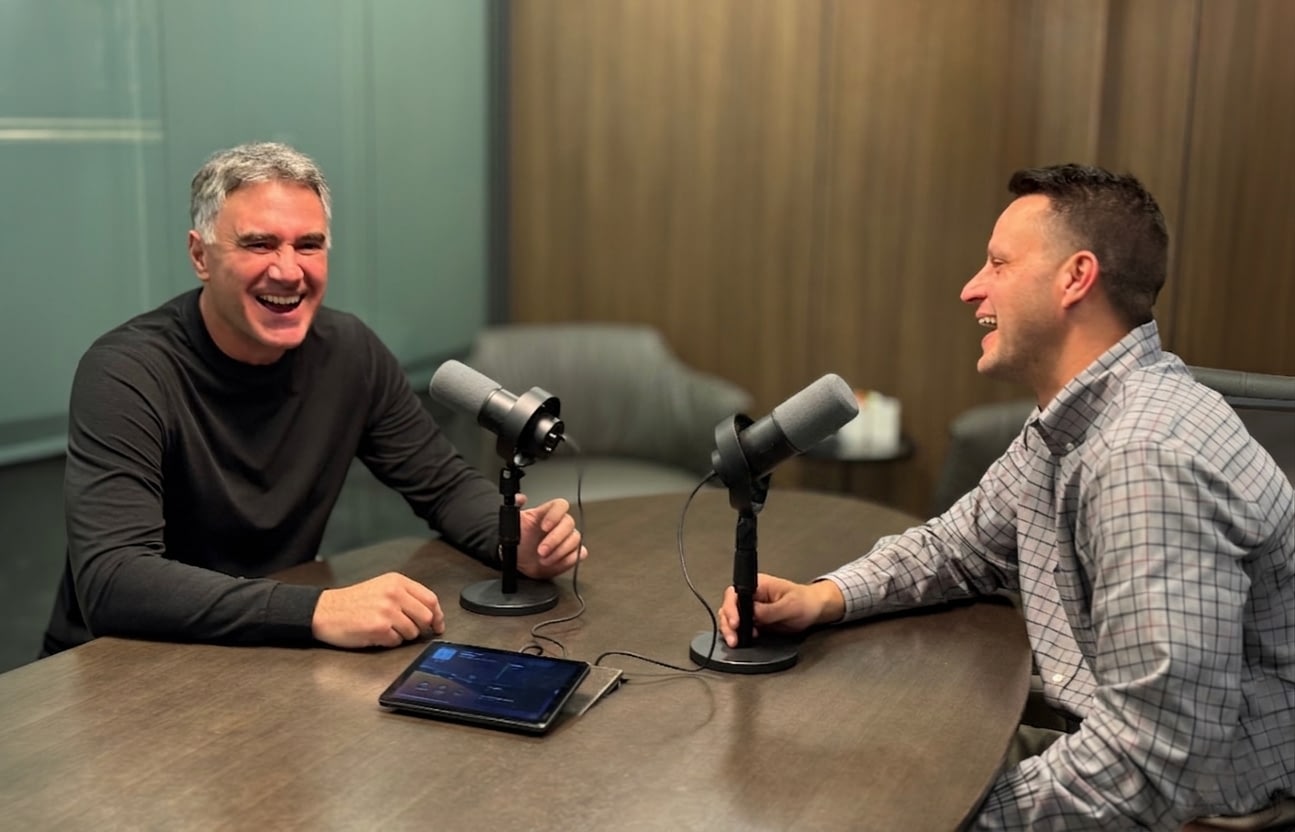 Doug Bevier and Dan Delisle laughing while recoding a podcast