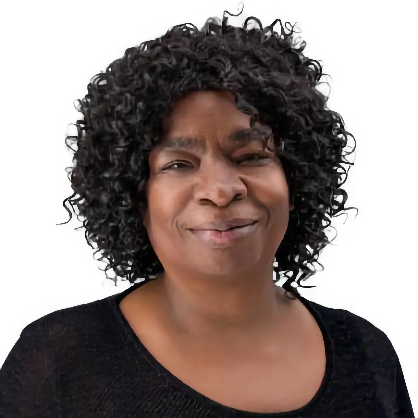 Smiling woman with curly hair against white background