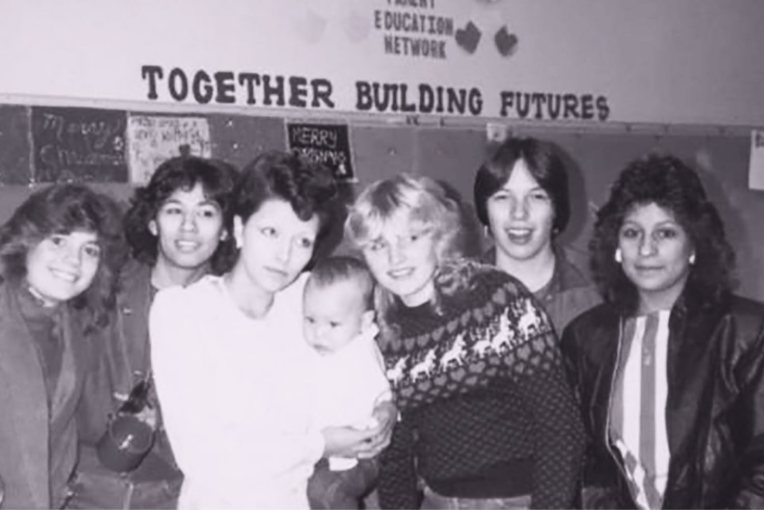 Group photo under Together Building Futures sign.