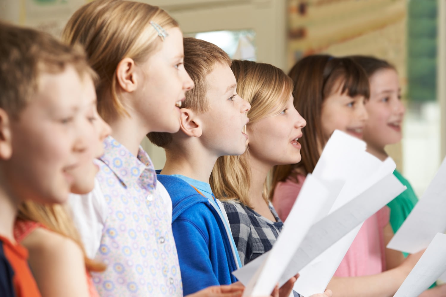 Group of kids sing a song together.