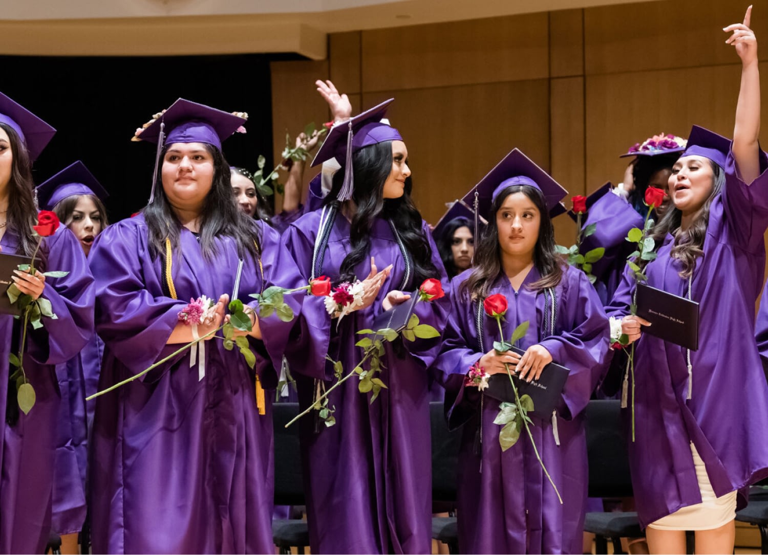 Students in purple gowns at graduation ceremony