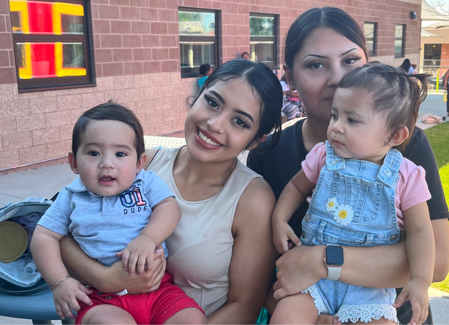 Two mothers holding children.