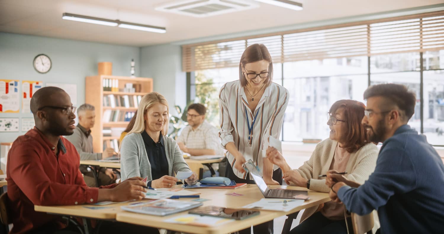 Leadership team meets around a table.