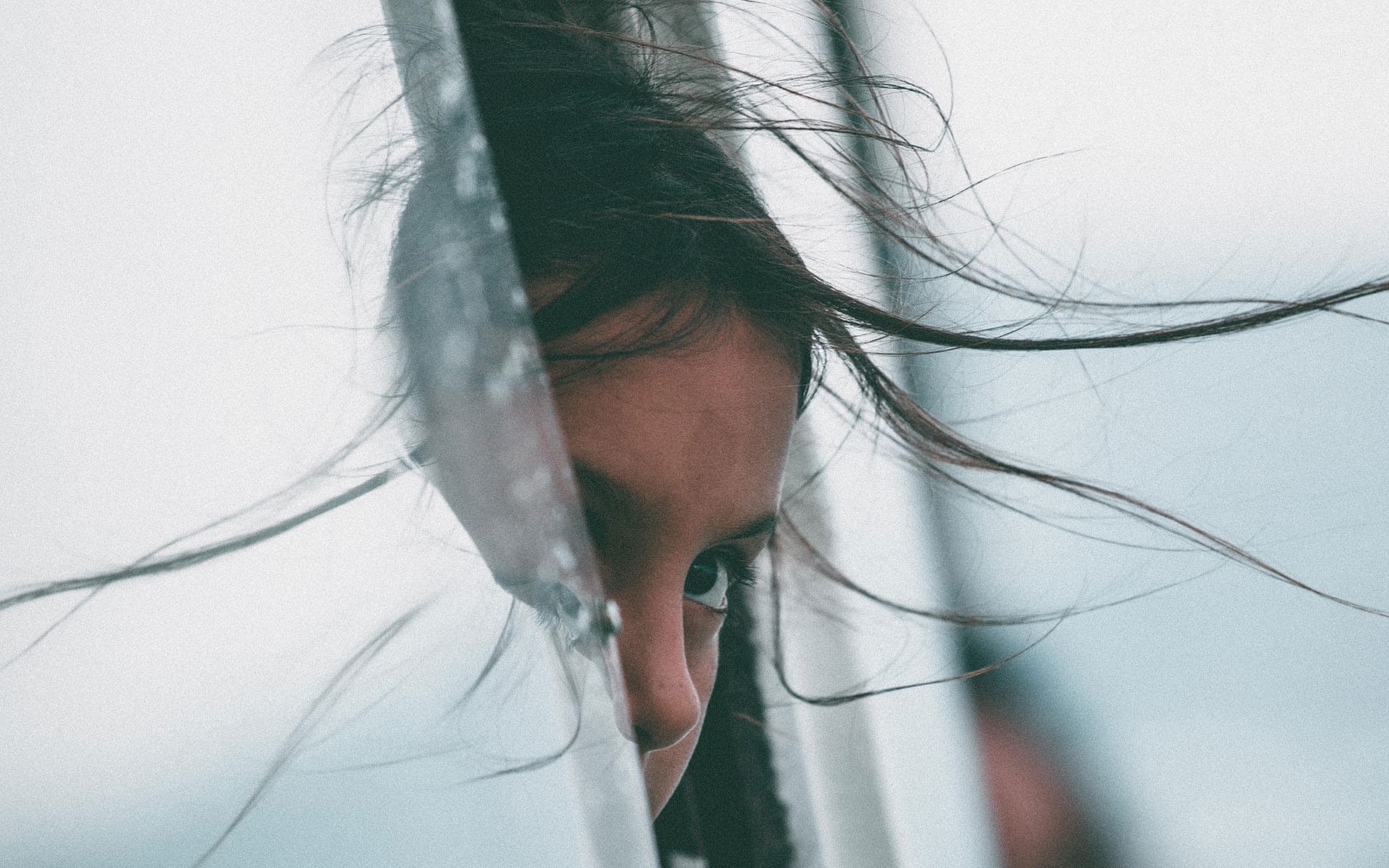 Child looking out through window with windy hair
