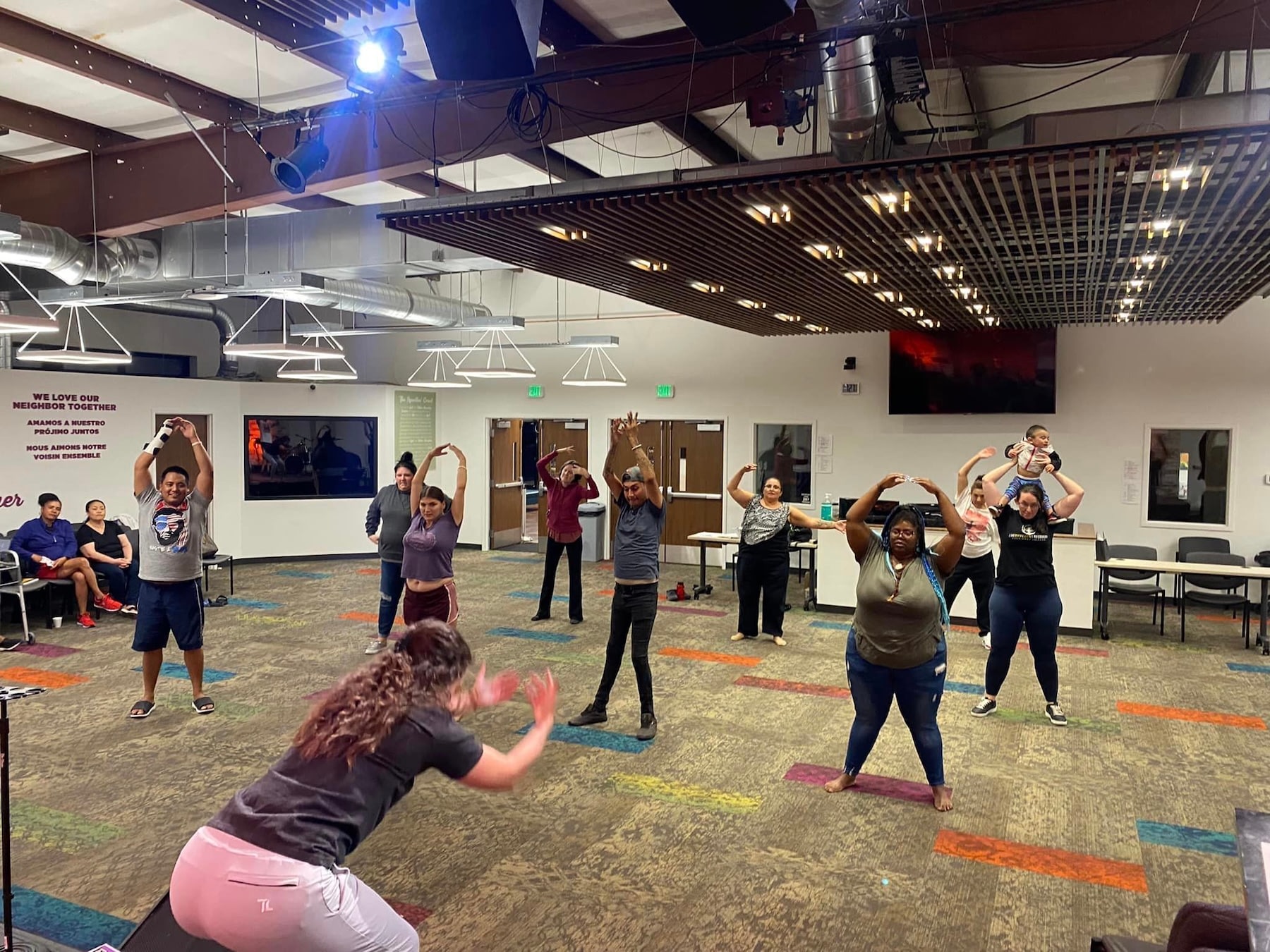 Community group stretching together in a multipurpose room