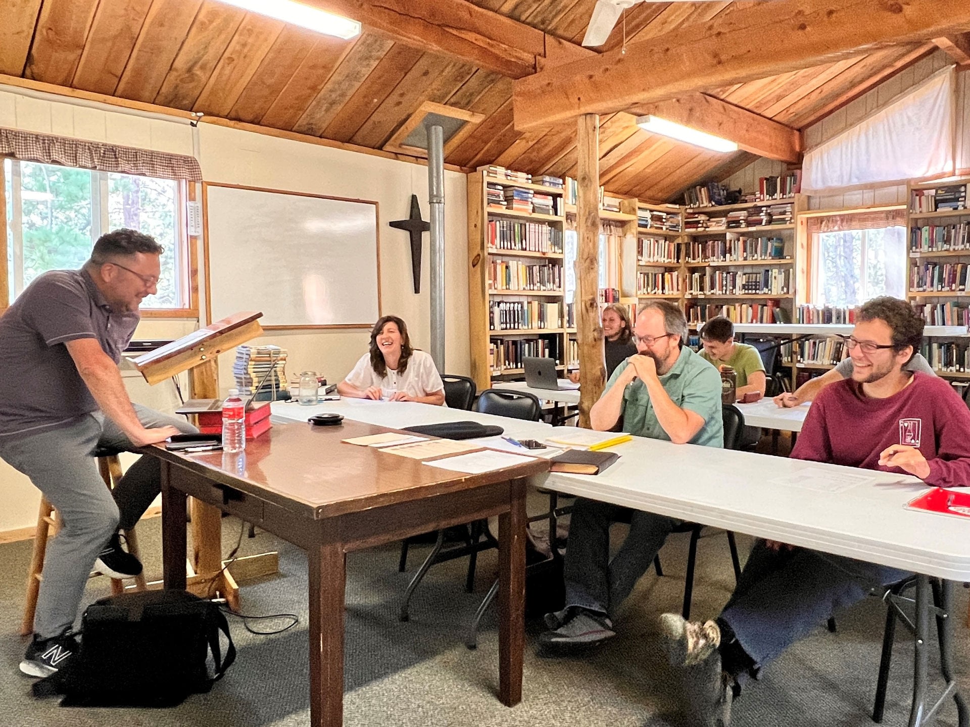 Instructor teaching small group in rustic library classroom