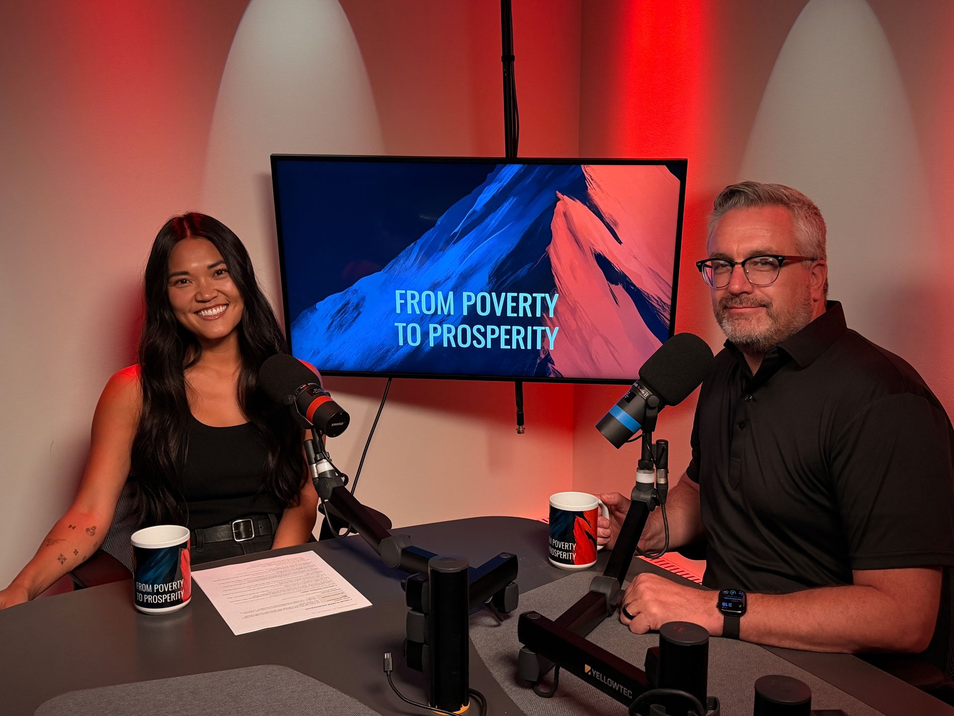 Two podcast hosts in From Poverty to Prosperity studio