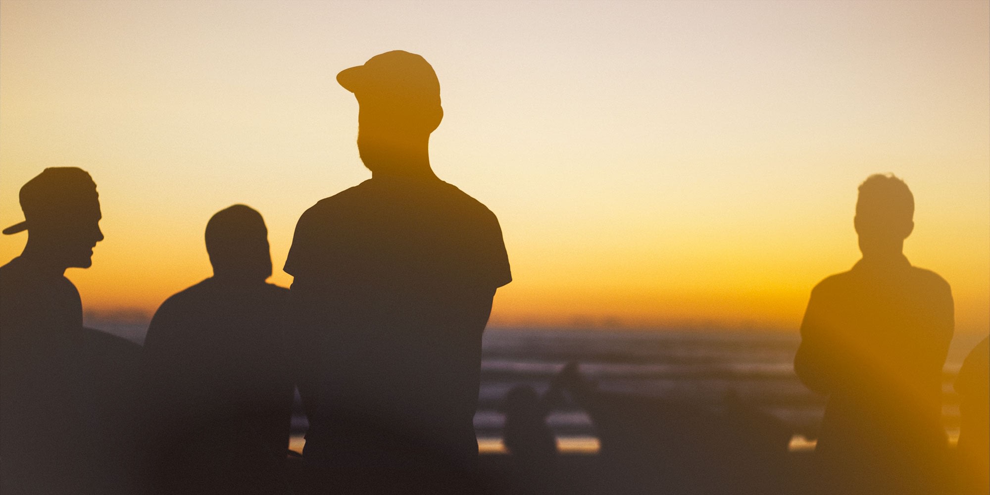 Men hanging out watching a sunset