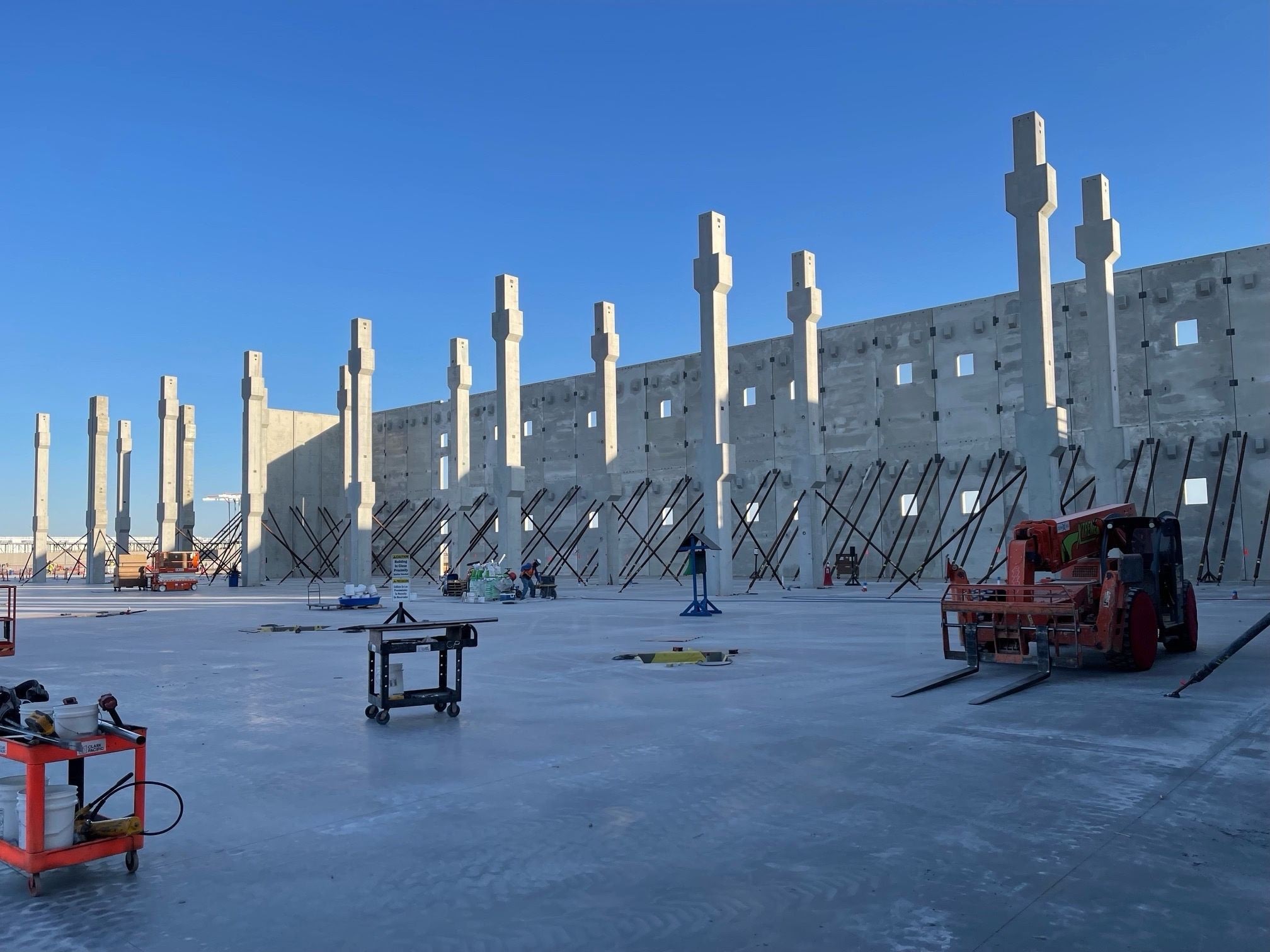 Construction site with concrete walls and pillars.