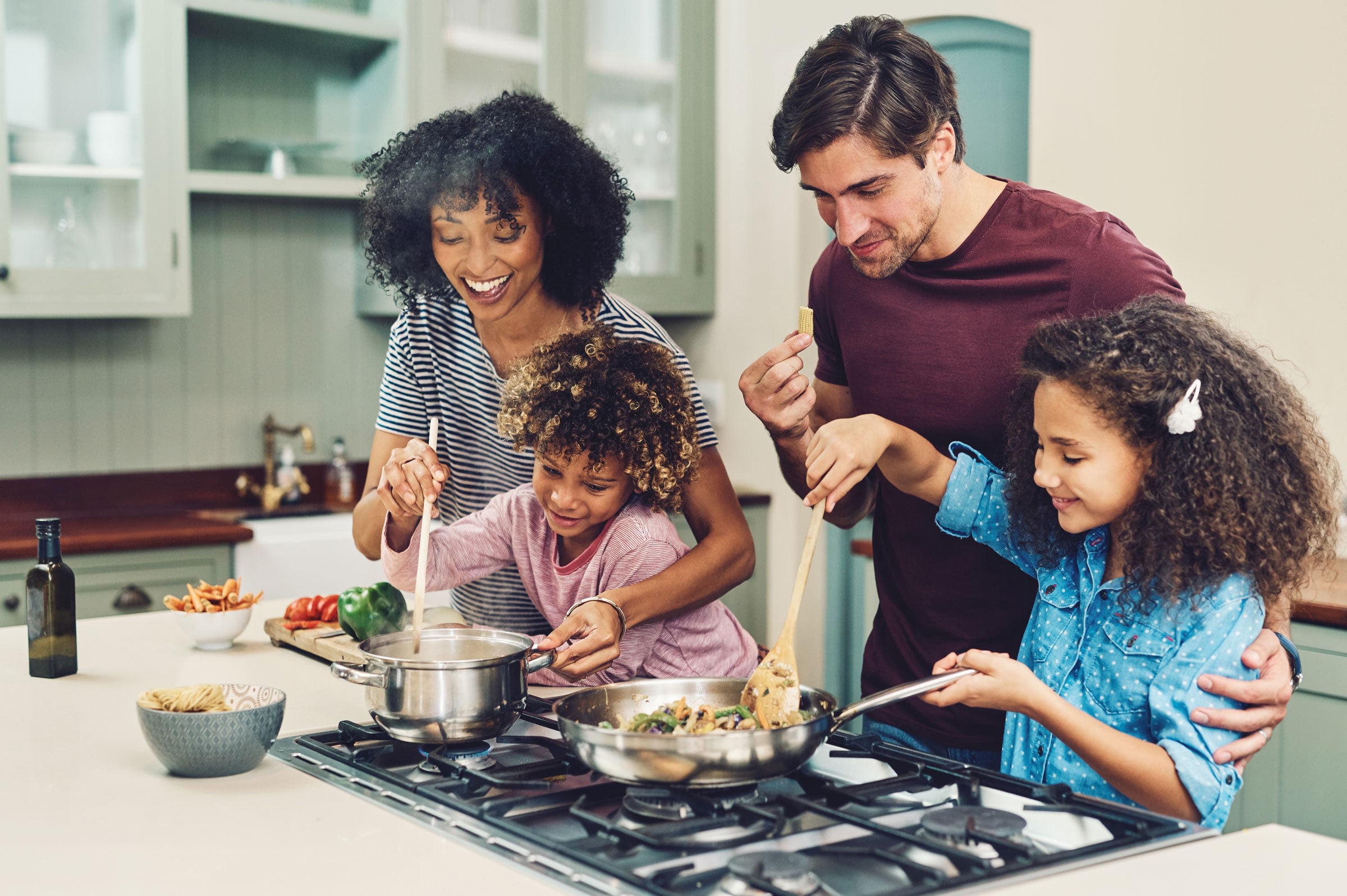 Family cooks a meal together.