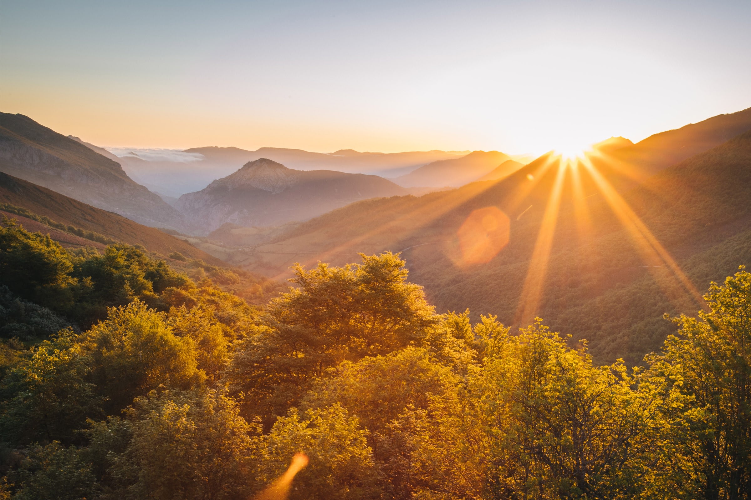 Sunrise over lush mountain landscape