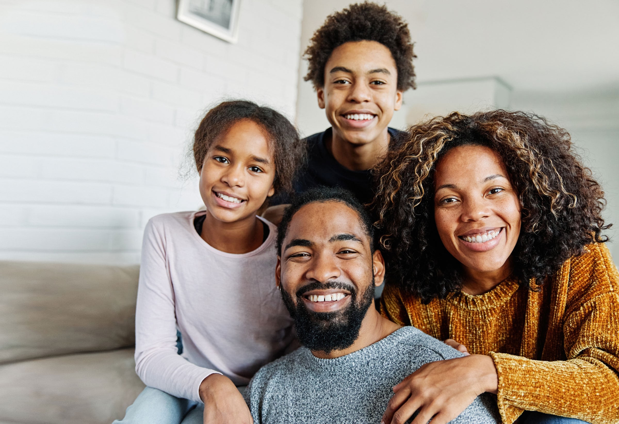 A family sits on a couch together.