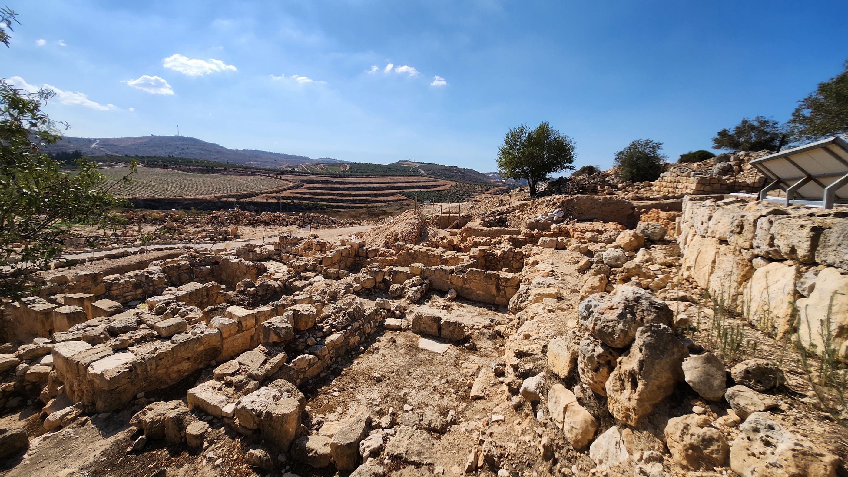 Ancient stone ruins and distant hillside view.