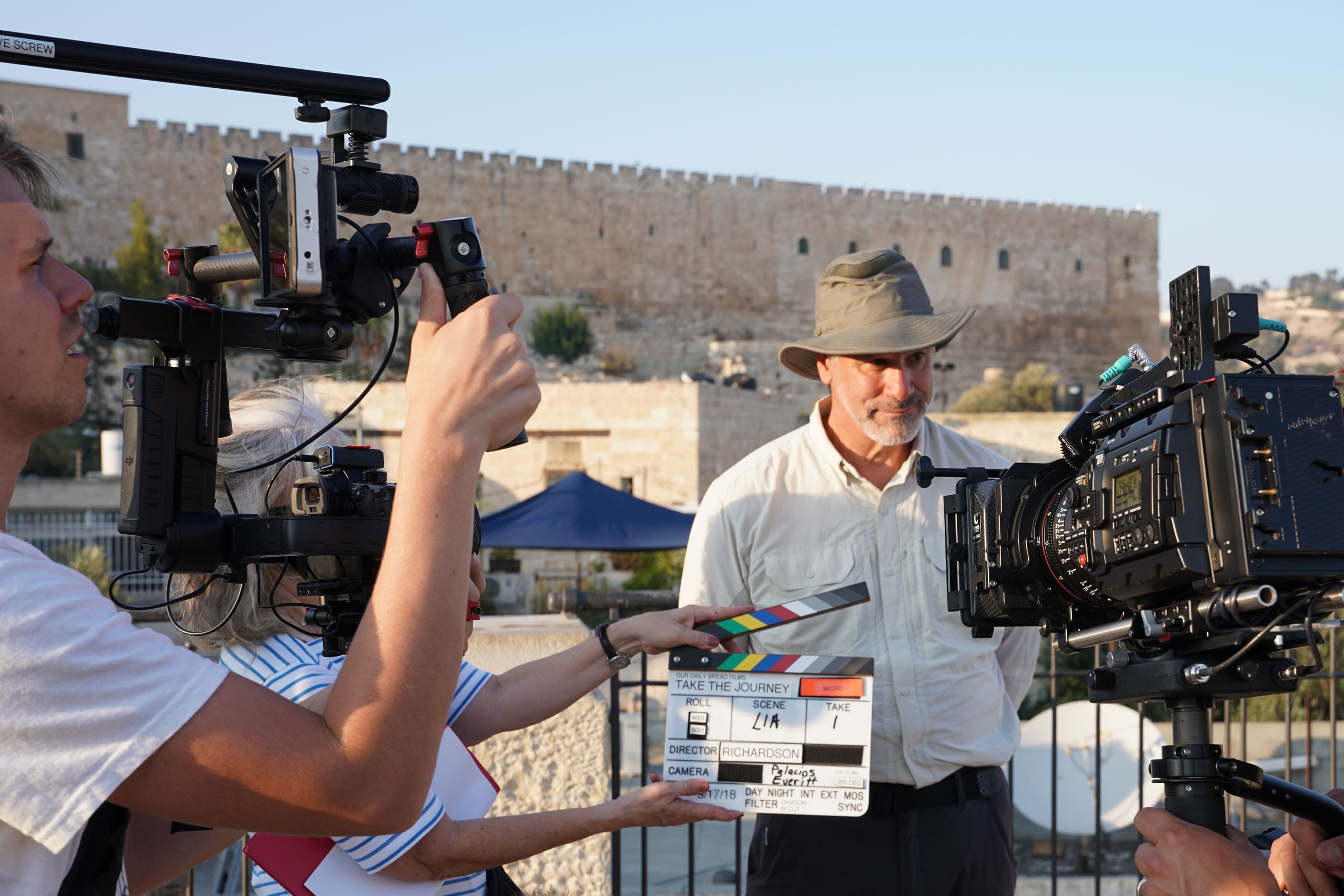 Filming crew with camera and clapperboard on set.