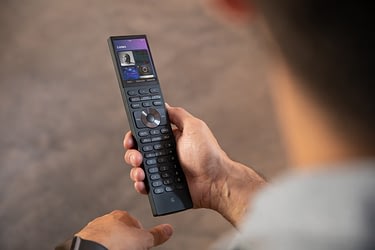 man holding control4 halo remote control