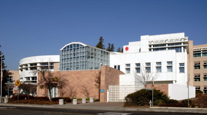 Modern building exterior with glass and stone elements.