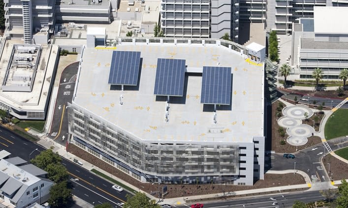 Aerial view of parking garage with solar panels.