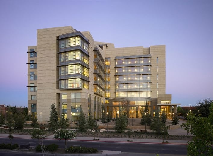Modern building with illuminated windows at dusk.