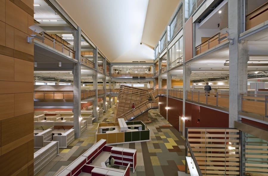 Modern multi-level office interior with colorful cubicles.