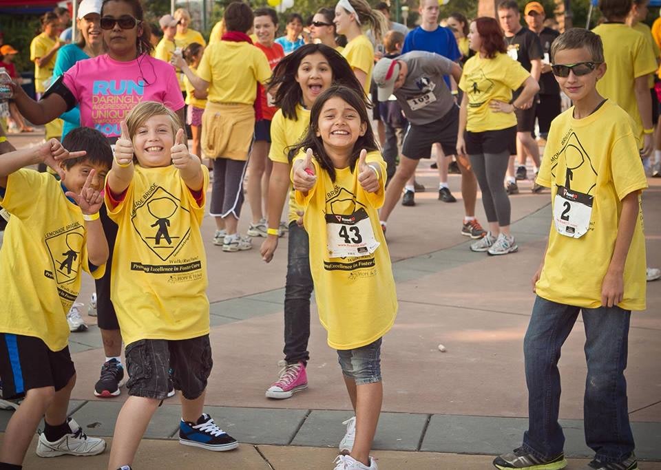 Kids smiling at outdoor charity fun run event